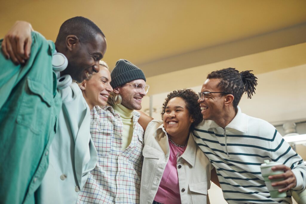 friendship day at work team members doing a group hug and smiling